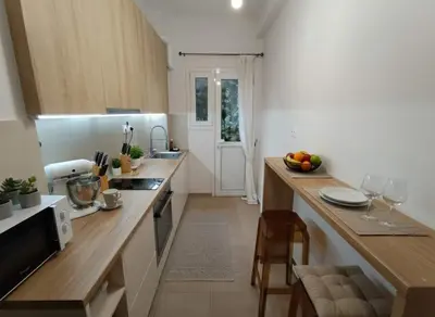 a kitchen with a counter with a sink and a counter top at Urban Soul Modern 2BR Retreat in Exarcheia in Athens