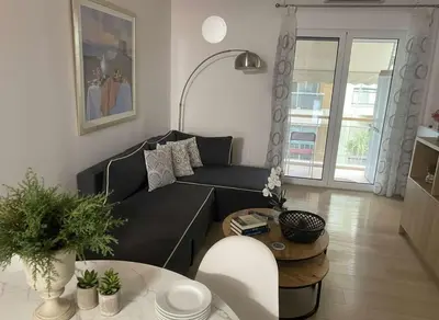 a living room with a black couch and a table at Urban Soul Modern 2BR Retreat in Exarcheia in Athens