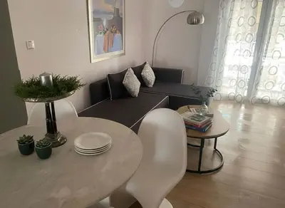a living room with a table and a couch at Urban Soul Modern 2BR Retreat in Exarcheia in Athens