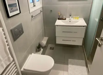 a small bathroom with a toilet and a sink at Urban Soul Modern 2BR Retreat in Exarcheia in Athens