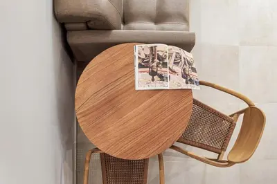 a wooden table with a magazine sitting on top of it at The Athens Luminous Suite in Athens