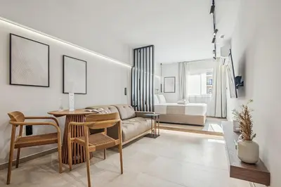 a living room with a couch and a table at The Athens Luminous Suite in Athens