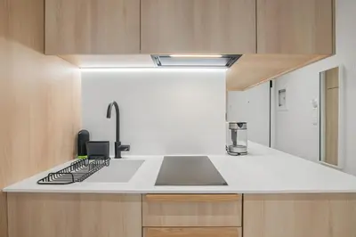 a kitchen with a sink and a stove at The Athens Solstice Suite in Athens