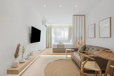 a living room with a couch and a table at The Athens Solstice Suite in Athens