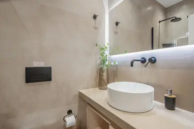 a bathroom with a white sink and a mirror at The Athens Solstice Suite in Athens