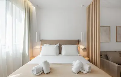 a bedroom with a bed with two towels on it at The Athens Solstice Suite in Athens