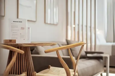a table and a chair in a living room at The Athens Edit Suite in Athens