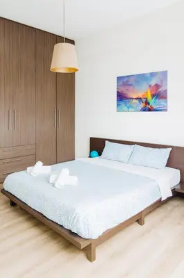 a bedroom with a large bed with white sheets at Panormou Urban Getaway Next to Metro Fast Wi-Fi in Athens