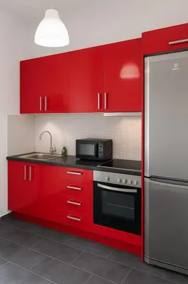 a kitchen with red cabinets and a stainless steel refrigerator at Panormou Urban Getaway Next to Metro Fast Wi-Fi in Athens