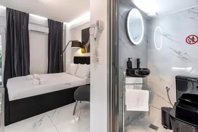 a small room with a bed and a mirror at Aqua Bliss Piraeus in Piraeus