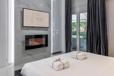 a bedroom with a bed with two pillows on it at Aqua Bliss Piraeus in Piraeus