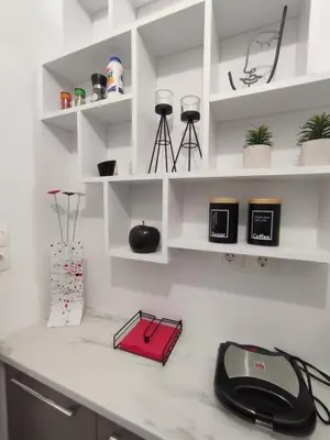 a white kitchen with a black phone on a counter at Urban Cocoon, Nice & Easy in Athens