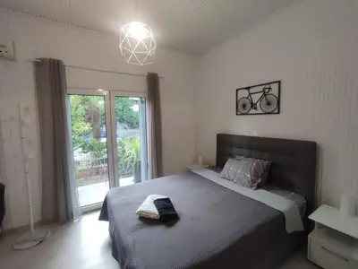 a bedroom with a bed and a large window at Urban Cocoon, Nice & Easy in Athens