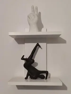 a statue of a woman sitting on a shelf with a hand at Urban Cocoon, Nice & Easy in Athens