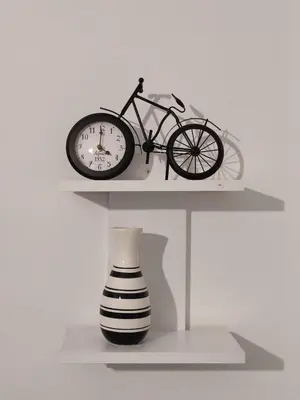a shelf with a bike and a clock and a vase at Urban Cocoon, Nice & Easy in Athens