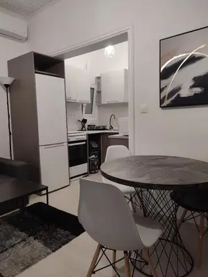 a kitchen with a table and chairs in a room at Urban Cocoon, Nice & Easy in Athens