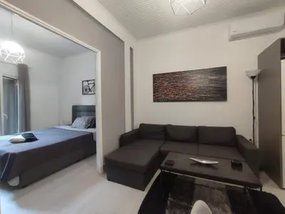 a living room with a couch and a bed at Urban Cocoon, Nice & Easy in Athens