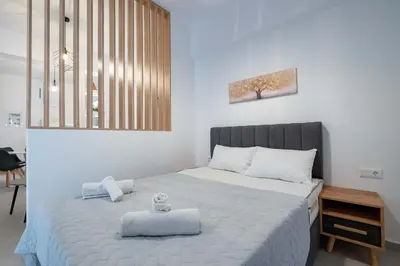 a bedroom with a bed with two towels on it at Piraeus Deluxe by the sea in Piraeus