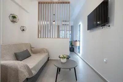 a living room with a couch and a table at Piraeus Deluxe by the sea in Piraeus
