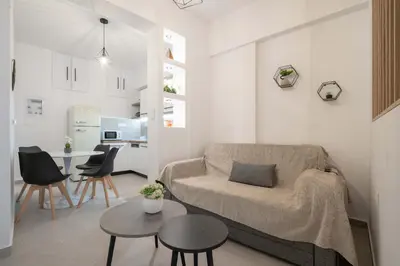 a living room with a couch and a table at Piraeus Deluxe by the sea in Piraeus