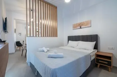 a bedroom with a bed with two towels on it at Piraeus Deluxe by the sea in Piraeus
