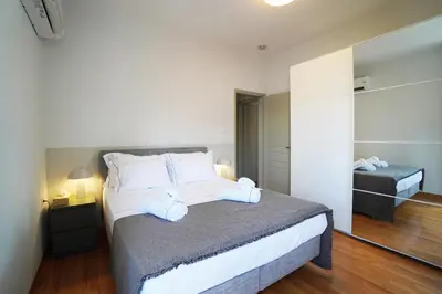 a bedroom with a bed with two towels on it at Athens Residence Ermou in Athens