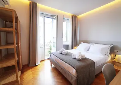 a bedroom with a bed with two towels on it at Athens Residence Ermou in Athens
