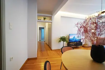 a living room with a table and a tv at Athens Residence Ermou in Athens