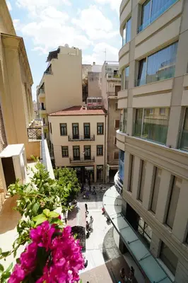 a view from a balcony of a building with pink flowers at Athens Residence Ermou in Athens