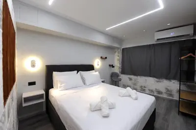 a bedroom with a bed with white towels on it at Cozy Loft Monastiraki in Athens
