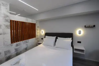 a bedroom with a large white bed with white pillows at Cozy Loft Monastiraki in Athens