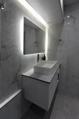 a white bathroom with a sink and a mirror at Cozy Loft Monastiraki in Athens