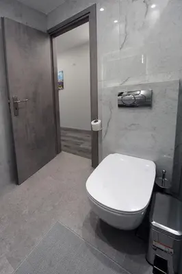 a bathroom with a white toilet and a sink at Cozy Loft Monastiraki in Athens