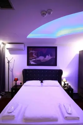 a bedroom with a large bed with purple lighting at Comfort Room 216 - Castle De Paris in Athens