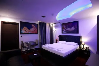 a bedroom with a large bed and a couch at Comfort Room 216 - Castle De Paris in Athens