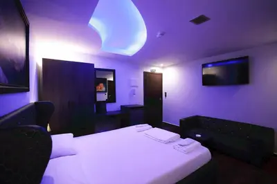 a purple room with a bed and a tv at Comfort Room 216 - Castle De Paris in Athens