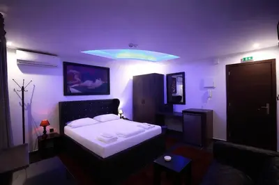 a bedroom with a bed in a purple room at Comfort Room 216 - Castle De Paris in Athens