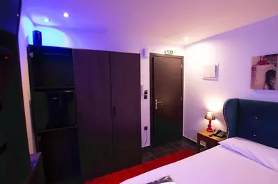 a hotel room with a bed and a closet at Comfort Room 217 - Castle De Paris in Athens