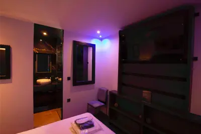 a purple room with a bed and a mirror at Comfort Room 217 - Castle De Paris in Athens