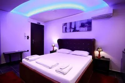 a purple room with a bed with towels on it at Comfort Room 218 - Castle De Paris in Athens