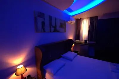 a bedroom with a bed with blue lights on it at Comfort Room 218 - Castle De Paris in Athens