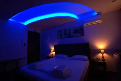 a blue room with a bed with a blue light at Comfort Room 218 - Castle De Paris in Athens