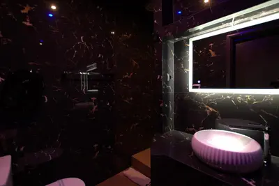 a bathroom with a pink sink and a mirror at Comfort Room 218 - Castle De Paris in Athens