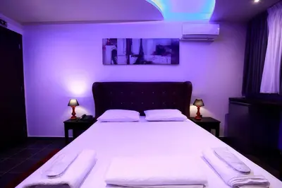 a bedroom with a large bed in a purple room at Comfort Room 218 - Castle De Paris in Athens