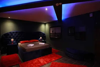 a dark room with a bed and a couch at Deluxe Suite 211 - Castle De Paris in Athens