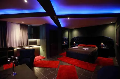 a room with a bed and a couch and blue lights at Deluxe Suite 211 - Castle De Paris in Athens