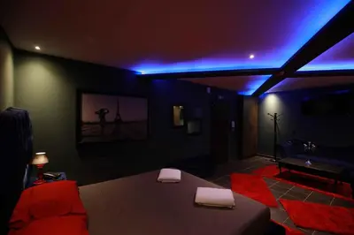 a living room with a bed and a blue light at Deluxe Suite 211 - Castle De Paris in Athens