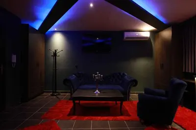 a living room with a couch and a table and blue lights at Deluxe Suite 211 - Castle De Paris in Athens