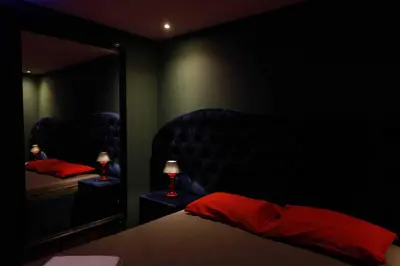 a bedroom with a bed and a large mirror at Deluxe Suite 211 - Castle De Paris in Athens