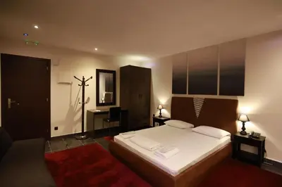 a bedroom with a large bed with white sheets at Deluxe Suite 212 - Castle De Paris in Athens